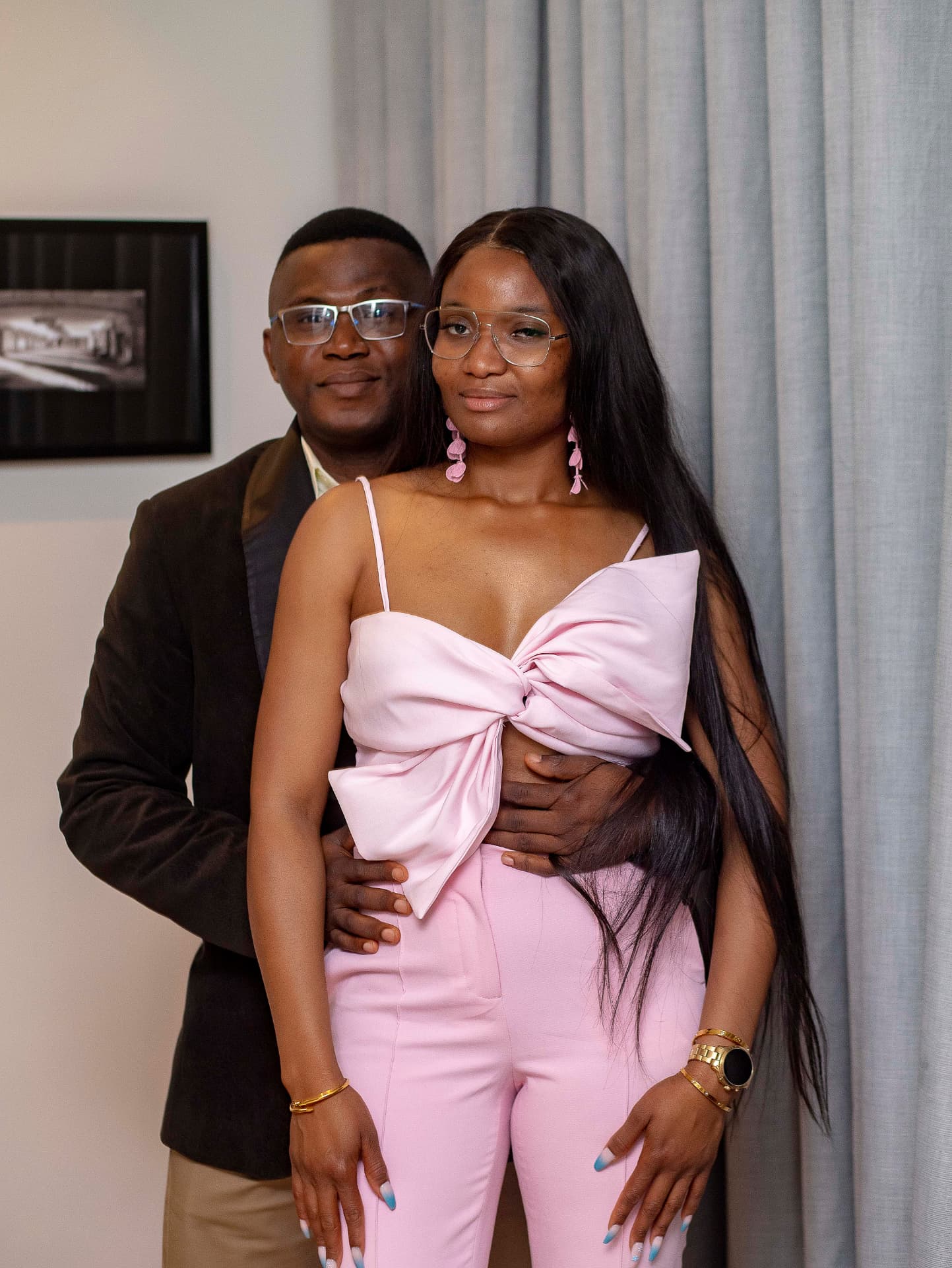 Tessy and Rayz standing close, smiling